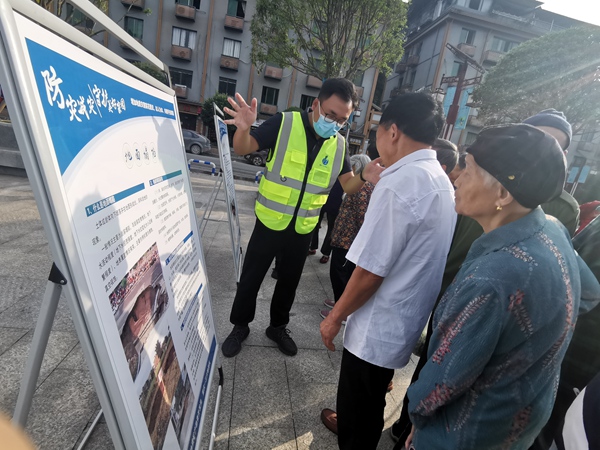 《“地災科普進萬家 防災減災靠大家”科普宣傳》。6月14日，在巴南區(qū)東溫泉鎮(zhèn)河邊廣場，重慶一三六地質隊隊員杜健正向過往群眾講解地災科普知識。楊靖攝