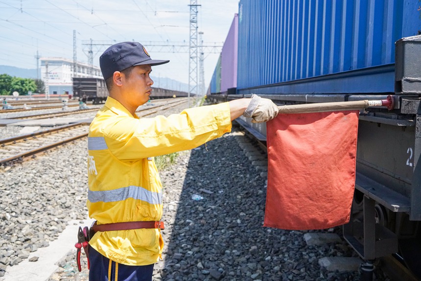 8月9日，重慶西車輛段貨車檢車員正在插設(shè)紅旗準(zhǔn)備作業(yè)。劉彪攝