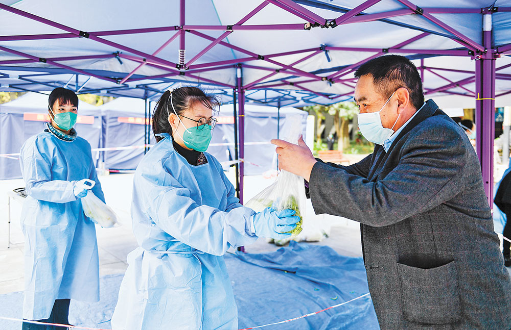 11月17日，兩江新區(qū)翠云街道翠渝路社區(qū)，尚格博園小區(qū)，周洋(中)正在給小區(qū)居民派送蔬菜。記者 齊嵐森 攝 視覺重慶