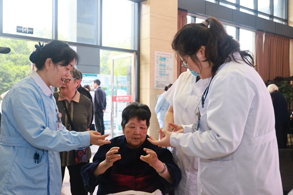 重慶市第十三人民醫(yī)院護(hù)師指導(dǎo)老年人進(jìn)行家庭康復(fù)訓(xùn)練。曾英豪攝