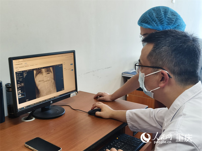 重慶醫(yī)科大學(xué)附屬兒童醫(yī)院兩江院區(qū)，醫(yī)生們通過醫(yī)檢互認(rèn)系統(tǒng)查看患兒在當(dāng)?shù)氐臋z查結(jié)果。人民網(wǎng) 陳琦攝