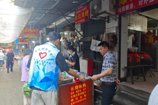 志愿者給商戶發(fā)放反詐傳單。重慶財經(jīng)學院供圖