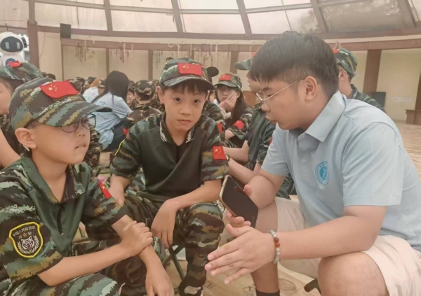 志愿者與小朋友交流AI反詐知識(shí)。李晨銘攝