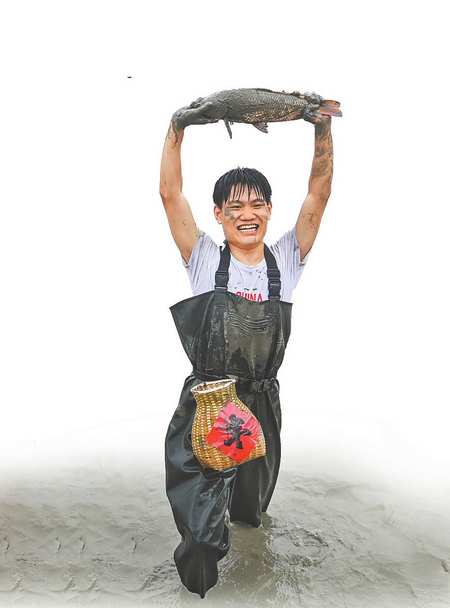 九月二十三日，忠縣馬灌鎮(zhèn)果園村，稻田摸魚比賽參賽者展示抓到的大魚。記者 鄭宇 攝\視覺重慶