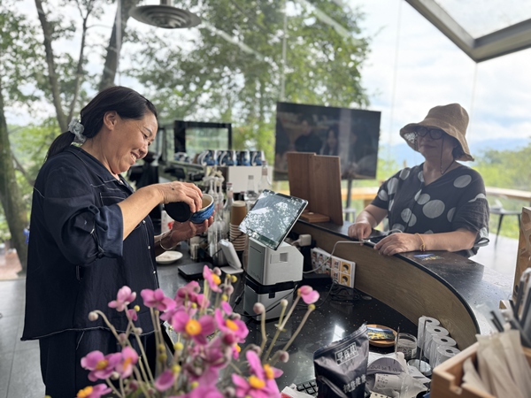 冉光芳為游客制作咖啡。莢天宇攝