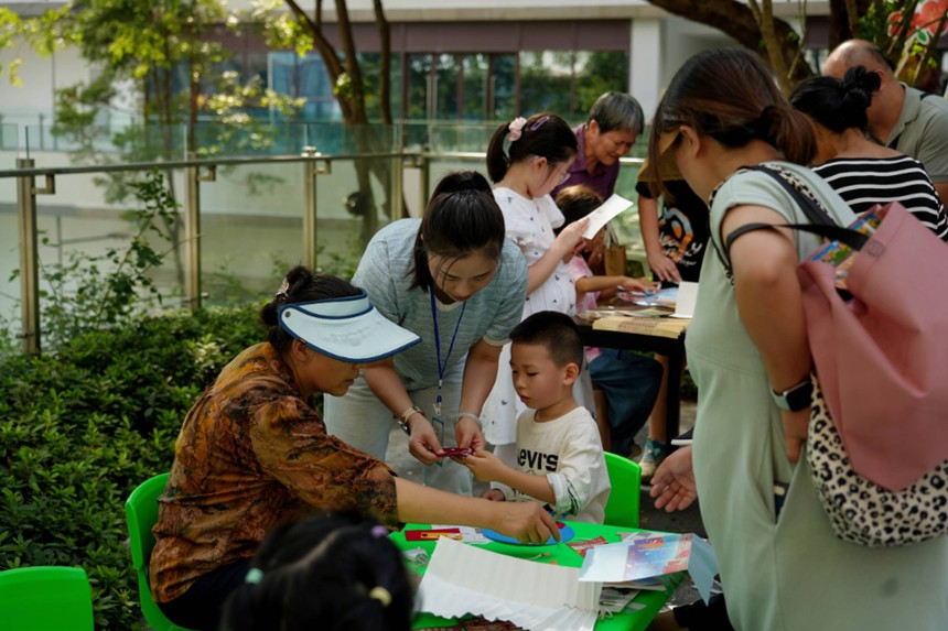 家長與孩子共同制作折扇和愛國主題貼畫。受訪者供圖