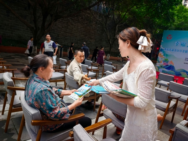 志愿者現(xiàn)場(chǎng)向居民宣傳便民服務(wù)相關(guān)政策。龍山街道供圖