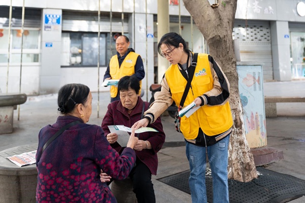 “渝電青松”志愿者向社區(qū)居民發(fā)放安全用電傳單。國網(wǎng)重慶永川供電公司供圖