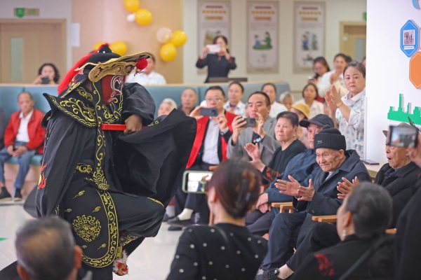 志愿服務(wù)隊(duì)正在為老人們表演川劇變臉。趙勇攝