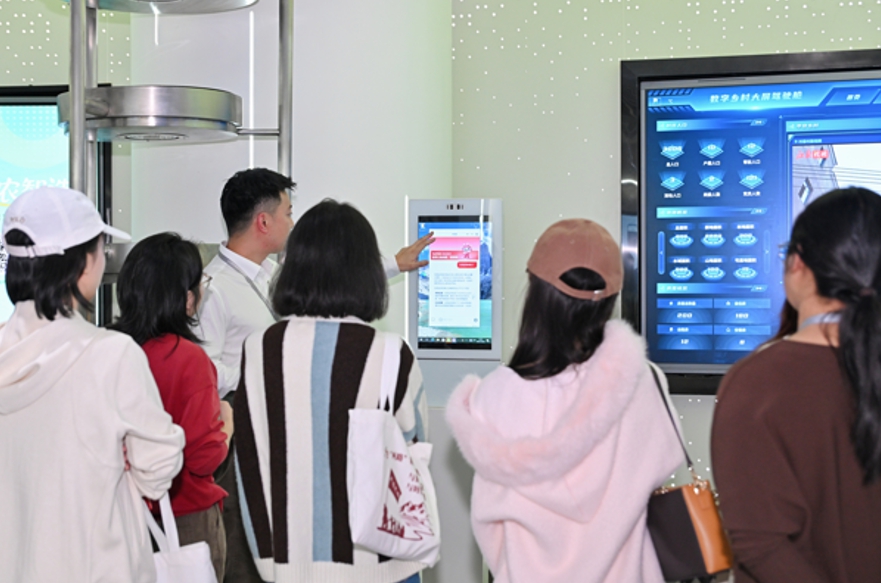 工作人員為眾人演示AI村委助手使用方法。主辦方供圖